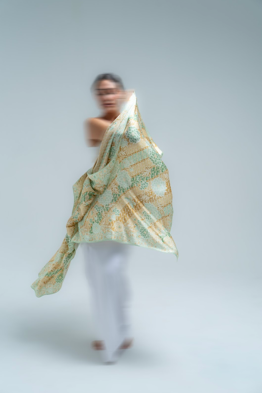 Person wearing a batik sarong on a plain background
