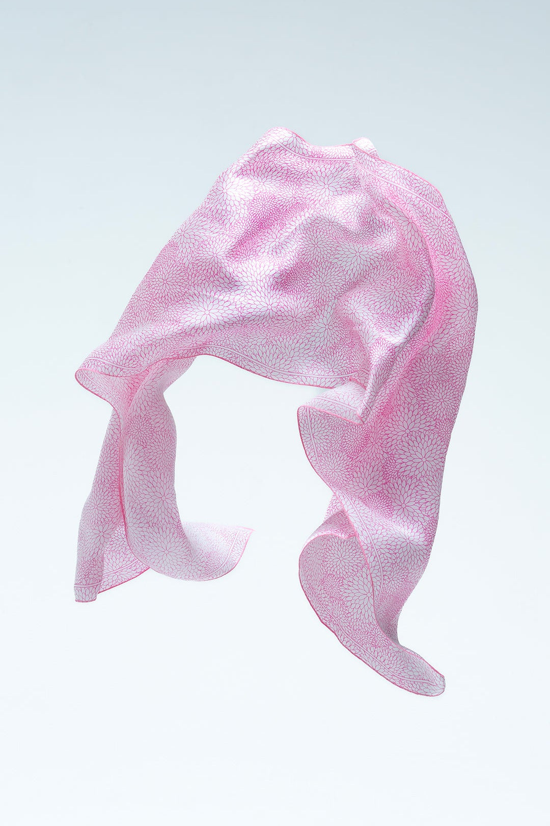 Pink blossom batik scarf on a light gray background