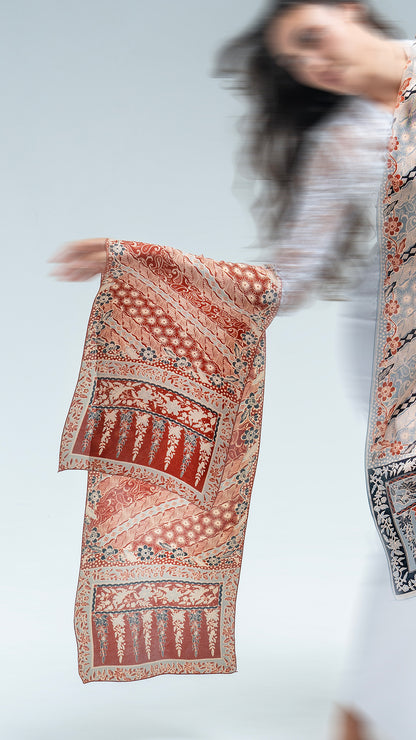Person holding a lengko batik scarf with a blurred background