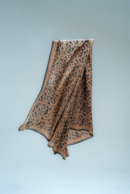 Daun Asem Black print sarong on a light gray background