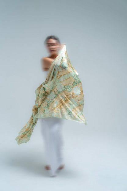 Person wearing a batik sarong on a plain background