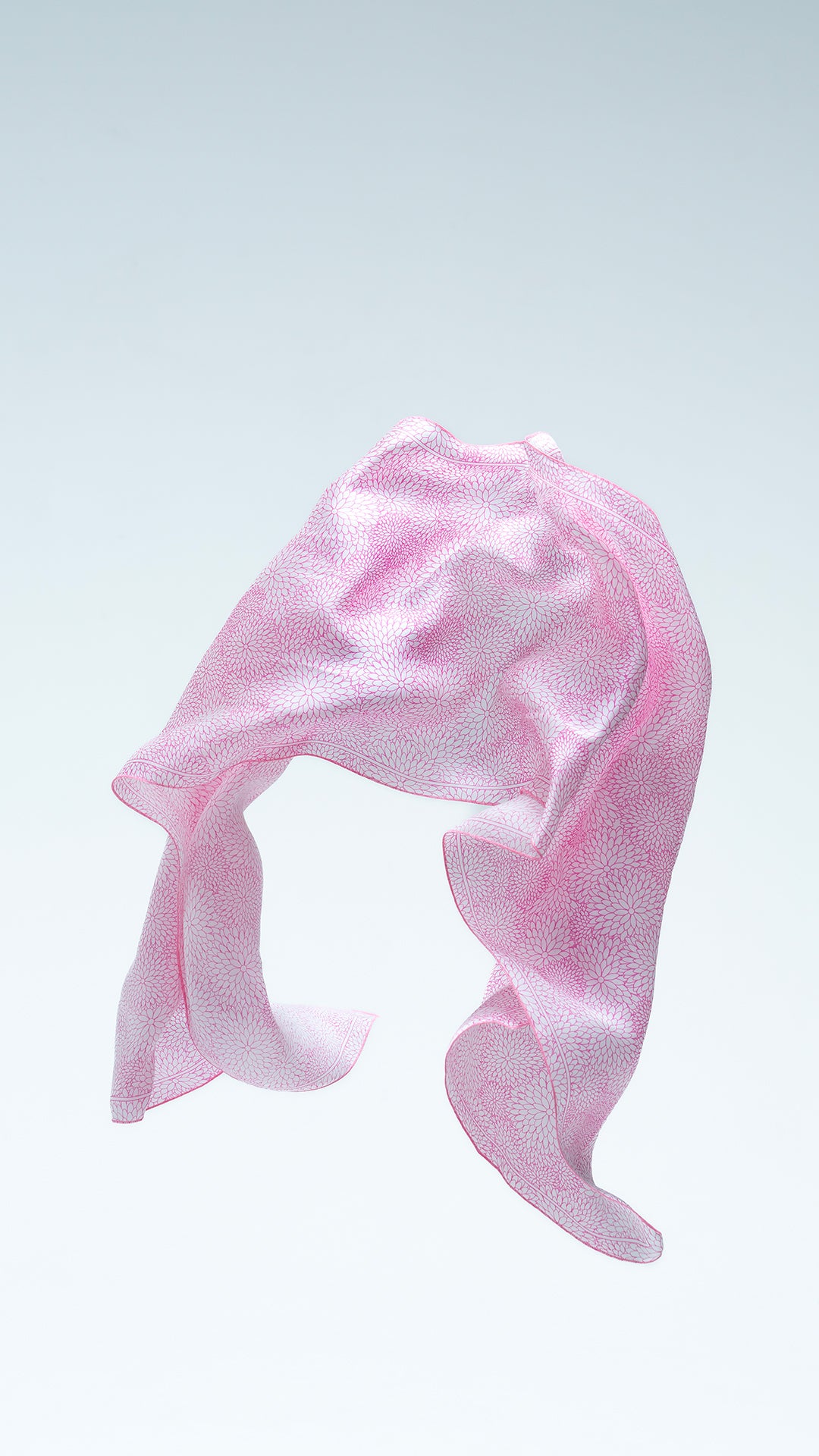 Pink blossom batik scarf on a light gray background