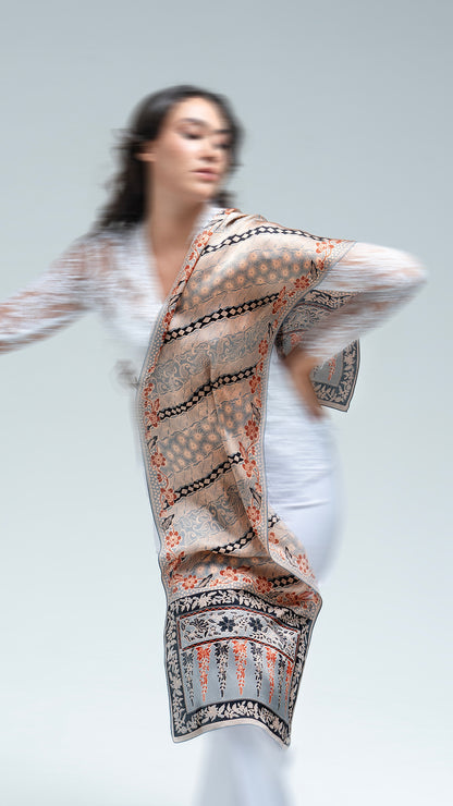 Woman wearing a lengko batik scarf on a plain background